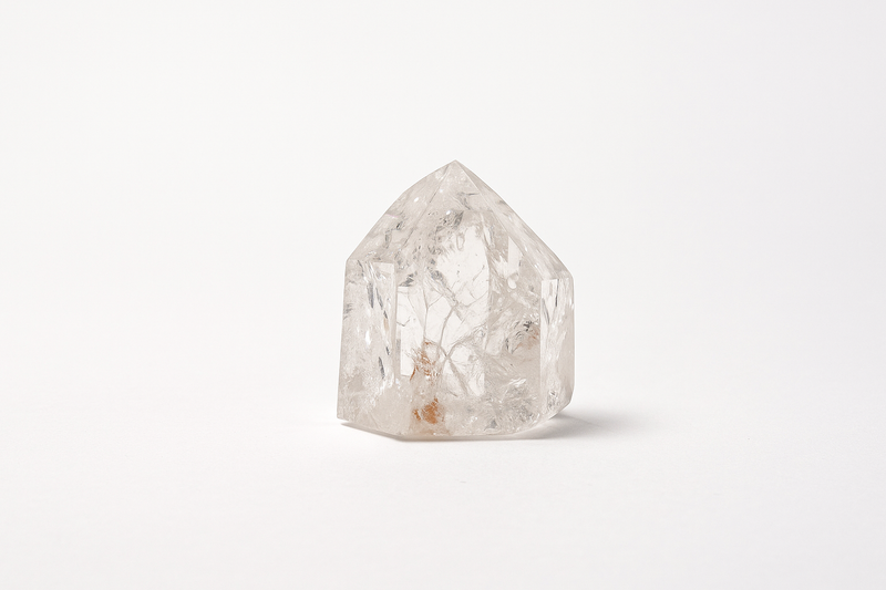 Polished mini clear quartz point with internal inclusions